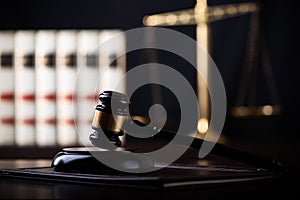 Judge gavel, scales of justice and law books in court