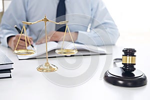 Judge gavel with scales of justice, male lawyers working having