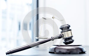 Judge gavel, scales of justice on the office desk, the white background office of a lawyer or judge