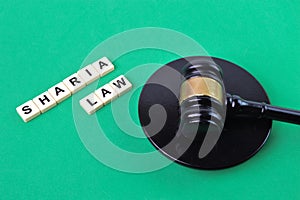 Selective focus of judge gavel and scrabble letters with text SHARIA LAW photo