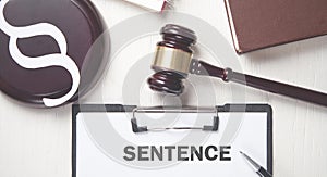 Judge gavel with Sentence text on clipboard