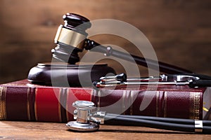 Judge Gavel And Soundboard On Law Book With Stethoscope