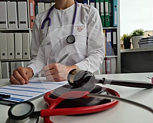 Judge gavel stethoscope and medical insurance closeup