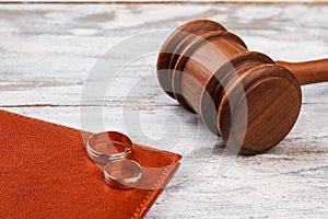 Judge gavel and wedding rings.