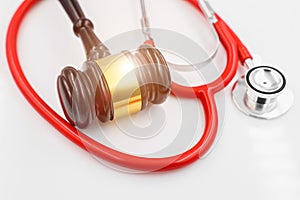 Judge hammer with stethoscope for doctor medical profession relate with legal court litigation image concept