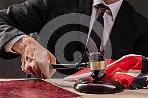 Judge hits the table with hammer. In the courtroom, the judge convicted lawyer. Judge`s gavel in hand photo