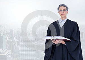 Judge holding book in front of bright city