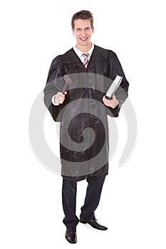 Judge holding gavel and book