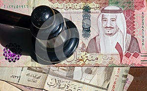 Judge hummer, Auctioneers Gavel or Hammer on Riyal, Saudi Arabian money photo