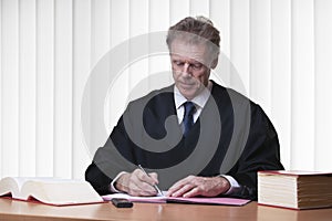 Judge or lawyer writing at his desk