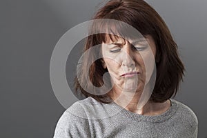 Judge mental concept for unhappy 50s woman