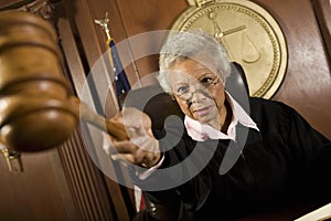 Judge Pointing Gavel In Courtroom photo