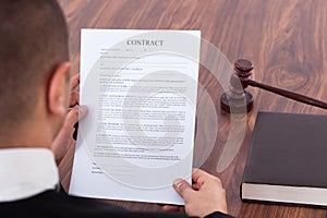 Judge reading contract in courtroom