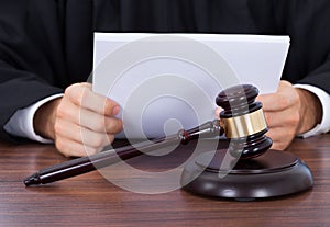 Judge reading documents at desk