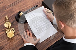 Judge Reading Paper In Courtroom