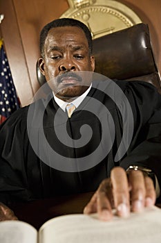 Judge Referring To Law Book