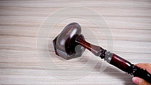 Judge\'s ceremonial wooden gavel hits the stand.