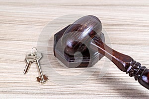 Judge\'s ceremonial wooden gavel on a stand next to the keys