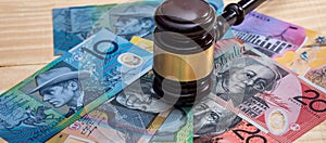 Judge's gavel on australian dollar banknotes closeup