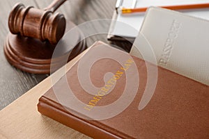 Judge`s gavel, book and documents on wooden table photo