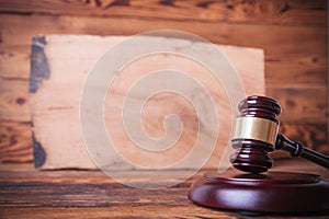 Judge`s gavel in front of a bog oak board