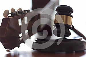 Judge`s gavel and guitar. Concept of entertainment lawsuit, music piracy and copyright protection photo
