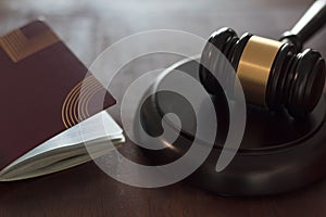 Judge`s gavel and passport document on wooden table