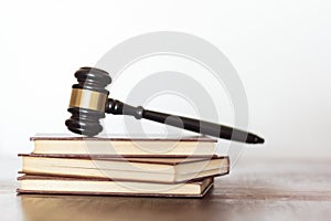Judge`s gavel on top of books. White background with copy space