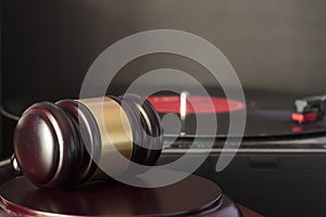 Judge`s gavel and vinyl record player. Concept of entertainment lawsuit, music piracy and copyright protection