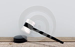Judge`s gavel in white and black on wooden floor