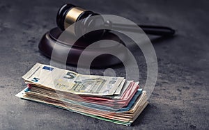 Judge's hammer gavel. Justice and euro money. Euro currency. Court gavel and rolled Euro banknotes.