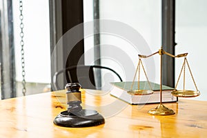 Judge`s hammer and golden scales on the lawyer`s desk in the office.