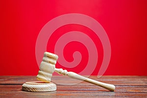 Judge`s hammer on a red background. The judicial system. Norms, rules and laws. Conflict resolution in court. Court case, settlin