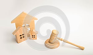 Judge`s hammer and wooden houses. Local government, self-government in a city or township. Decentralization, reservation. Adminis