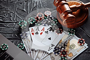 Judge`s wooden gavel, poker chips, money and playing cards. Concept of Law and regulation of gambling