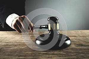 Judge striking gavel on sounding block. Law and Justice concept photo