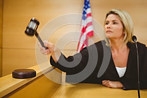 Judge about to bang gavel on sounding block photo