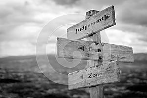 judgement free zone text quote on wooden signpost photo