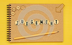 judgement word written on wood block. judgement text on table, concept.