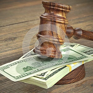 Judges or Auctioneer Gavel And Dollars Cash On Wooden Table