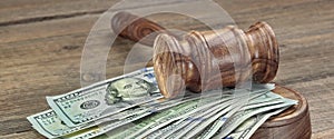 Judges or Auctioneers Gavel And Money Stack On Wooden Background