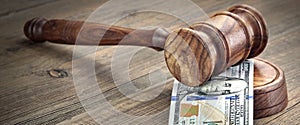 Judges or Auctioneers Gavel And Money Stack On Wooden Background