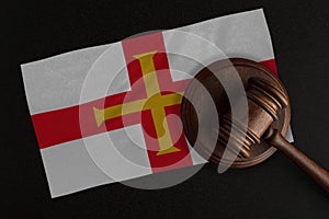 Judges gavel and the flag of Guernsey. Law and Justice. Constitutional law