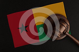 Judges gavel and the flag of Guinea. Law and Justice. Constitutional law