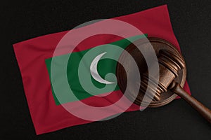 Judges gavel and the flag of Maldives. Law and Justice. Constitutional law