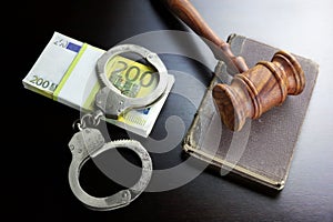 Judges Gavel, Handcuffs, Euro Cash And Book On Black Table