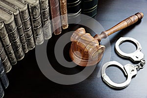 Judges Gavel, Handcuffs And Old Book On The Black Table