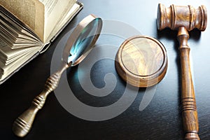 Judges Gavel, Magnifier And Old Book On The Black Table