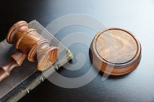 Judges Gavel And Old Book On The Black Wooden Table