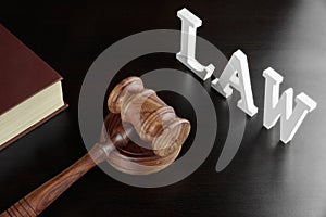 Judges Gavel, Red Book And Sign LAW On Black Table